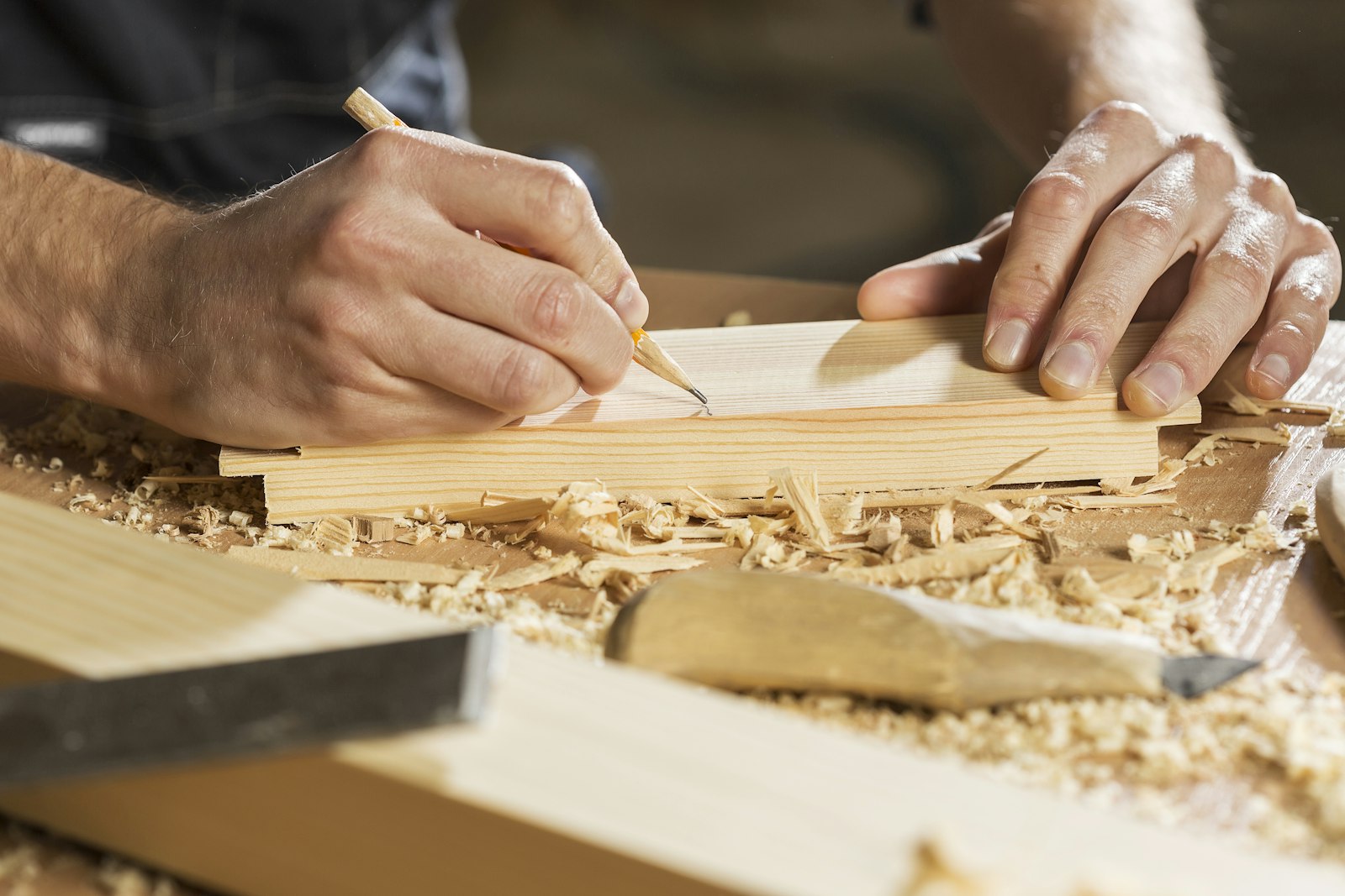 a person cutting a piece of wood
